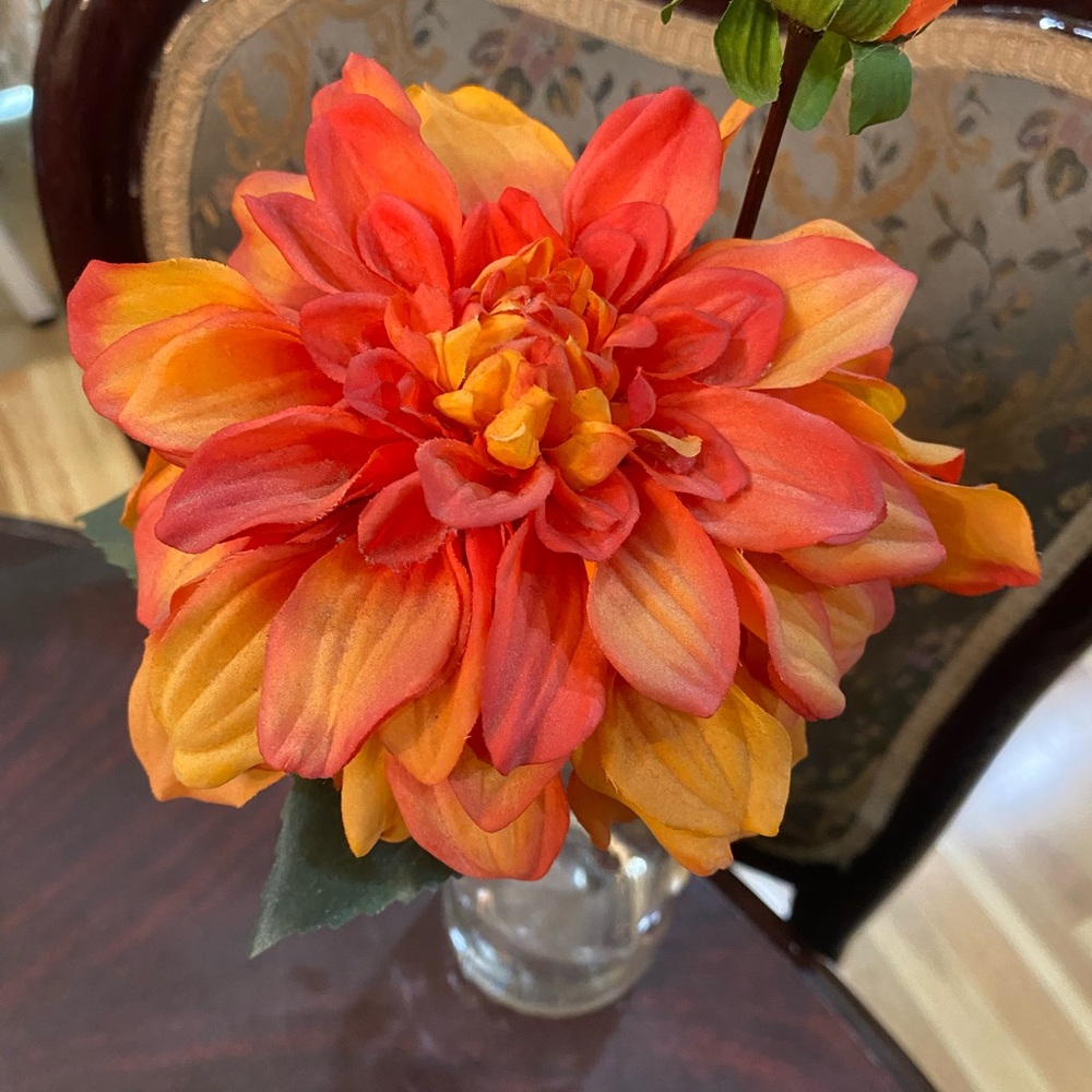Silk flower stem in a small vase